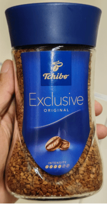 Tchibo coffee bottle held in a hand