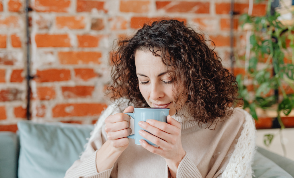 Person smelling coffee cup